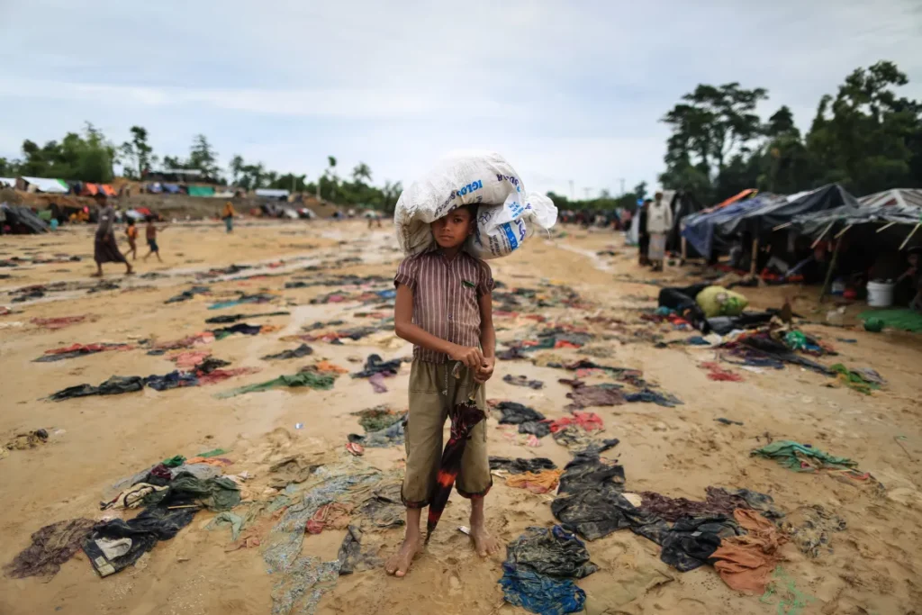 Bamboo and tarpaulin shelters packed across a hillside in a Rohingya refugee camp